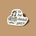Sticker with a graphic of a woman with crossed arms and text 'Is he dead yet?' on a beige background