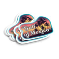 A stack of die-cut stickers featuring a sunset beach scene with palm tree silhouettes and the text 'Gulf of Mexico' in white script, shown on a plain white background.