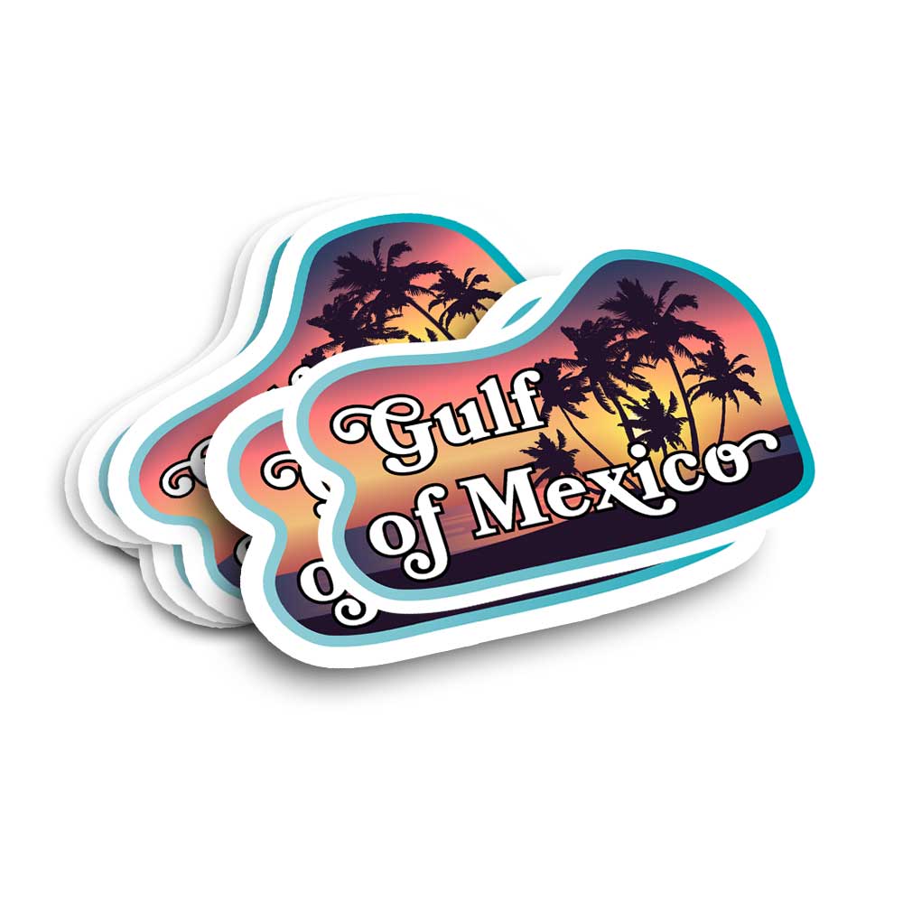 A stack of die-cut stickers featuring a sunset beach scene with palm tree silhouettes and the text 'Gulf of Mexico' in white script, shown on a plain white background.